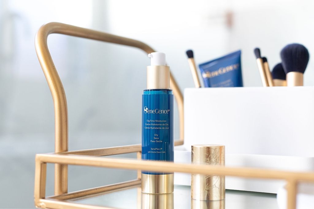 SeneGence products including a blue moisturizer bottle and gold-capped makeup